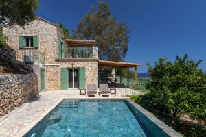an external view of a villa with a swimming pool at Villa Sevastoula (formerly Villa Skalita) in Ratzaklíon