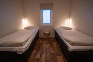 Postel nebo postele na pokoji v ubytování Marsfjäll Mountain Lodge Stugor i Saxnäs