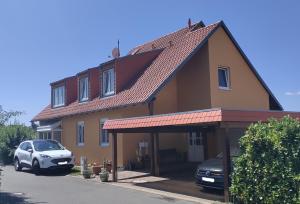 a house with a car parked in front of it at Sonne, Mond und Sterne in Moritzburg