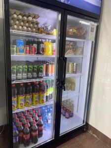 a refrigerator filled with lots of sodas and drinks at Aport hostel Alma-Ata in Almaty