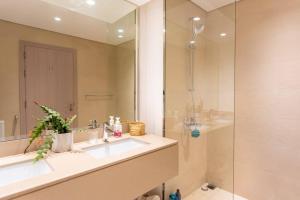 a bathroom with a sink and a shower at Modern2BR ElegantYas Island703 in Abu Dhabi +21 photos