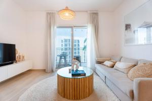 a living room with a couch and a coffee table at Modern2BR ElegantYas Island703 in Abu Dhabi