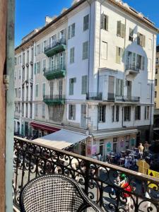 a chair sitting on a balcony in front of a building at Vera Nizza in Nice