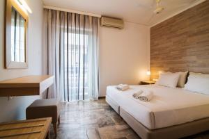 Ένα ή περισσότερα κρεβάτια σε δωμάτιο στο Polydoros Hotel Apartments