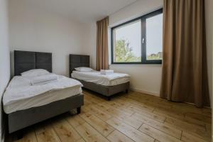 Postel nebo postele na pokoji v ubytování Apartamenty u Cherubinów + 11 fotografií
