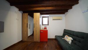 a living room with a green couch and a red refrigerator at Muyo House in Urla