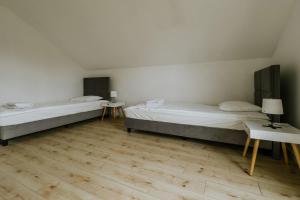 Postel nebo postele na pokoji v ubytování Apartamenty u Cherubinów