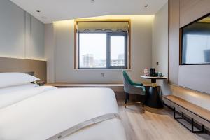 Postel nebo postele na pokoji v ubytování Elong RuiYun Hotel Fuyang Normal University