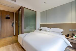 Postel nebo postele na pokoji v ubytování Elong RuiYun Hotel Fuyang Normal University