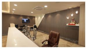 a conference room with a long table and chairs at The Riverside Inn in Vidisha