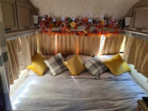 a bed in the back of a rv with christmas decorations at Squirrel Tails in Endon