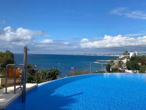 a swimming pool with a view of the ocean at Complejo Navío in Benalmádena