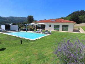a house with a swimming pool in a yard at Basto Village House - Eco Smart Luxury Villa in Cabeceiras de Basto