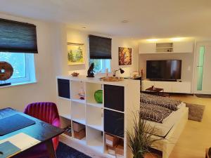a living room with a large shelving unit at WOLFSHÖHLE Schwarzwald-Apartment in Achern