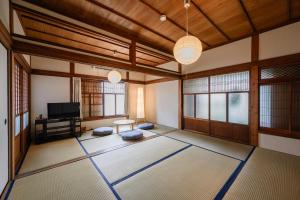 a room with a large room with a tv at Kizuna House Yuzuriha in Minamiawaji