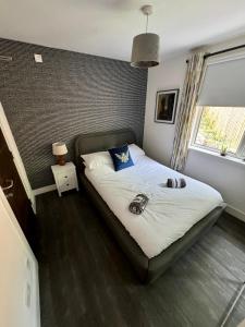 a bedroom with a bed with two shoes on it at Woodlands House in Alexandria