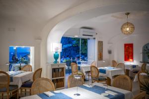 a restaurant with tables and chairs and a window at Hotel Villa Gabrisa in Positano