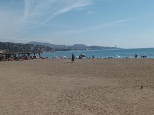 a group of people on a beach with the ocean at Mediterranean vibes in Málaga