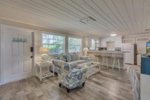 a living room with a couch and a kitchen at Coastal Dream Beach House in Clearwater Beach +25 photos