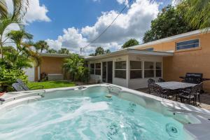 a swimming pool in front of a house at Coconut Breeze III - Monthly Beach Rental in Clearwater Beach