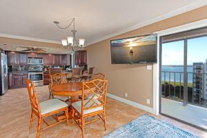 a kitchen and dining room with a table and chairs at Sand Key South Beach Condo #910 in Clearwater Beach
