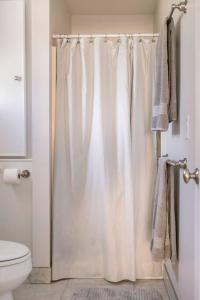 a bathroom with a shower curtain and a toilet at Goodland Waterfront Cottage in Goodland +38 photos