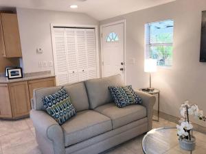a living room with a couch and a table at Goodland Waterfront Cottage in Goodland