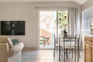 a living room with a table and chairs and a television at Goodland Waterfront Cottage in Goodland