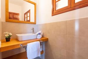 a bathroom with a sink and a mirror at La Casa del Molinero in Mogán +12 photos