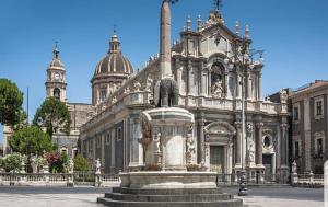 a large building with a statue in front of it at Risorgimento House in Catania