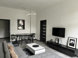a living room with a couch and a table at Strzelce Queen in Strzelce Opolskie
