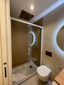 a bathroom with a toilet and a glass shower at Residenza Leonina in San Martino in Pensilis