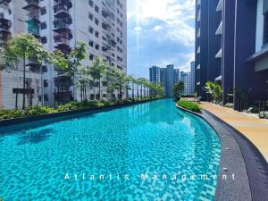 a large swimming pool in a city with tall buildings at Sungai Besi, Uno Promenade, Nearby Bukit Jalil & Salak Selatan MRT by Atlantis Management in Kuala Lumpur
