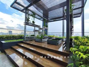 a rooftop garden with a pergola and plants at Sungai Besi, Uno Promenade, Nearby Bukit Jalil & Salak Selatan MRT by Atlantis Management in Kuala Lumpur