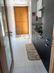 a kitchen with a sink and a counter top at Apparemment magnifique vue mer in Sousse