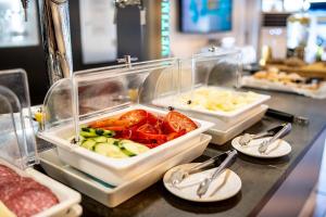 a buffet with several trays of food on a counter at Planet Hotels BLUE - Adults Only 16 years in El Arenal +8 photos