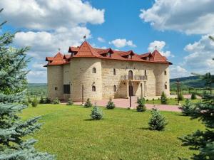a large brick building with a red roof at Castel Unghern in Ivancea