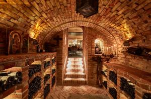 a wine cellar with an archway in a brick wall at Hotel Alpina in Ischgl