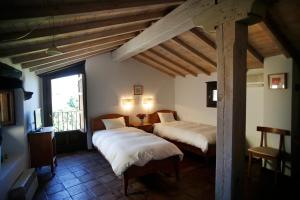 Postel nebo postele na pokoji v ubytování Casa Rural Hosteria Cantarranas