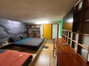 a bedroom with a bed and a table in it at Bungalow K House, 2brs, Center of Old Quarter, HoanKiem Lake in Hanoi