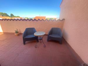 two chairs and a table on a patio at Chambre tout confort in Saint-Nazaire
