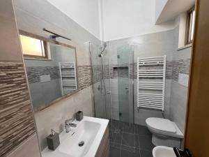 a bathroom with a toilet and a sink and a shower at Civico 11 in Reggio Calabria +11 photos