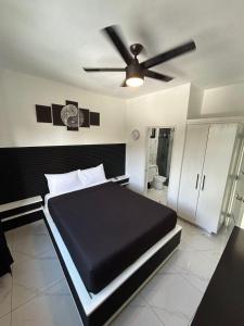 a bedroom with a bed and a ceiling fan at Level suites Penthouse in Sosúa +44 photos