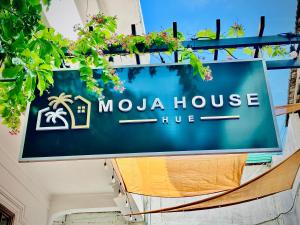 a sign for a maua houseue on a building at MOJA HOUSE l Homestay Huế in Thôn Dương Xuân Hạ