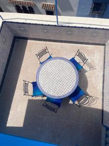 a table sitting on top of a swimming pool at Casa Voyager 'secret garden terrace' in Chefchaouen