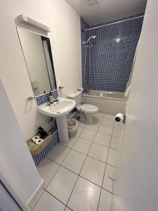 a bathroom with a sink and a toilet and a mirror at Key West Suites in Wexford +17 photos