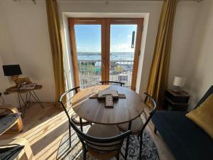 a table and chairs in a living room with a window at Key West Suites in Wexford