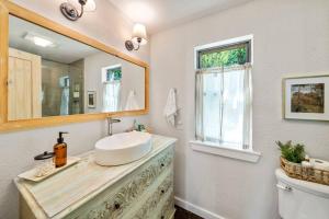 een badkamer met een wastafel en een spiegel en een toilet bij Lakefront Cottage- late summer price decrease! in Pittsburg +18 foto's