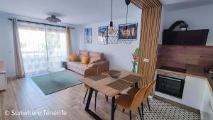 a living room with a table and a couch at Cozy apartment with wonderful view - Los Cristianos in Arona