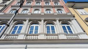a building with windows and a street light at Pep's Rooms by the sea in Trieste